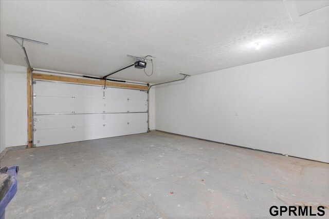 216 St Andrews Loop, Malvern, IA 51551 - garage featuring a garage door opener