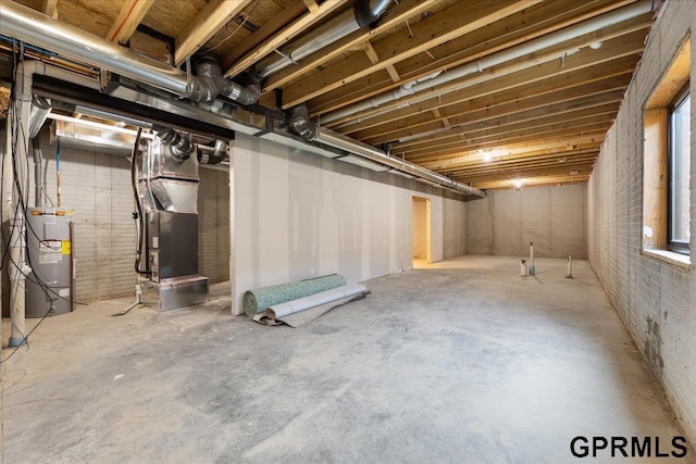 216 St Andrews Loop, Malvern, IA 51551 - unfinished below grade area with water heater, brick wall, and heating unit