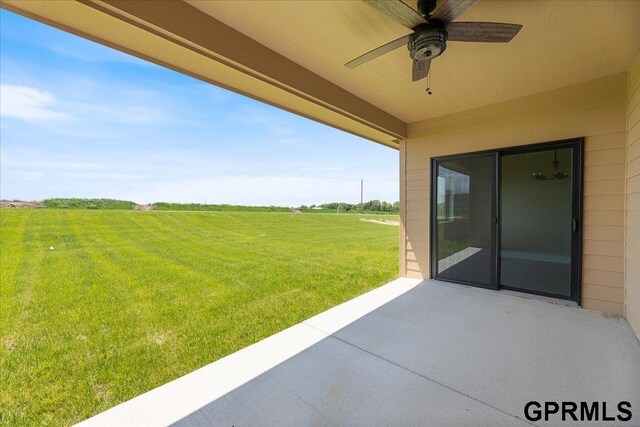 216 St Andrews Loop, Malvern, IA 51551 - view of green lawn featuring a patio, a ceiling fan, and a rural view