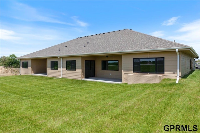 216 St Andrews Loop, Malvern, IA 51551 - back of house with a patio, a yard, and roof with shingles