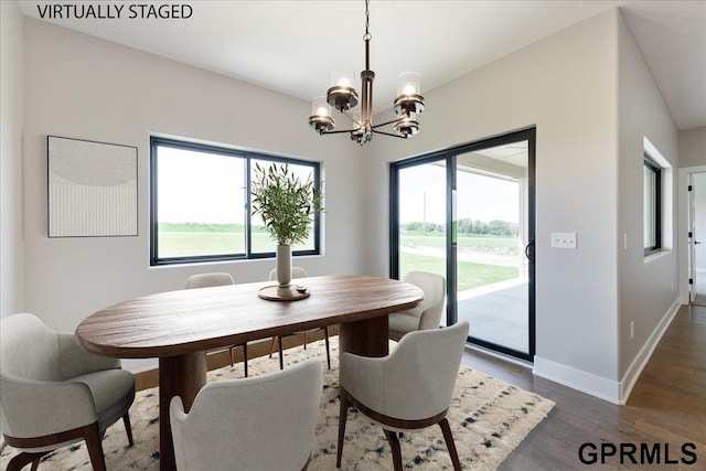 216 St Andrews Loop, Malvern, IA 51551 - dining room with a chandelier, wood finished floors, and baseboards