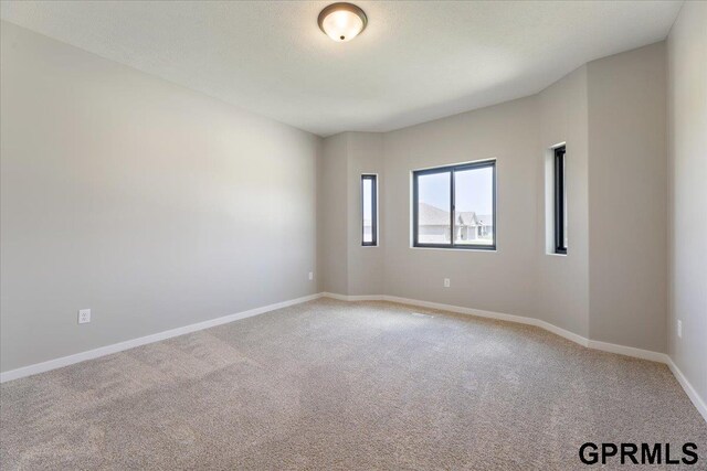 216 St Andrews Loop, Malvern, IA 51551 - empty room featuring carpet floors and baseboards