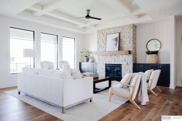 living room featuring a fireplace, beamed ceiling, dark hardwood / wood-style flooring, and coffered ceiling