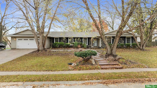 ranch-style home with a garage and a front lawn