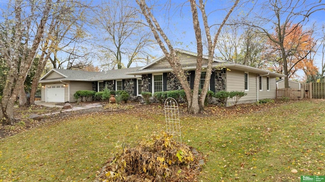 single story home featuring a front lawn and a garage