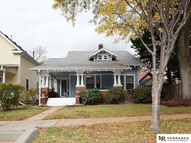 view of front of home featuring a front yard and a porch