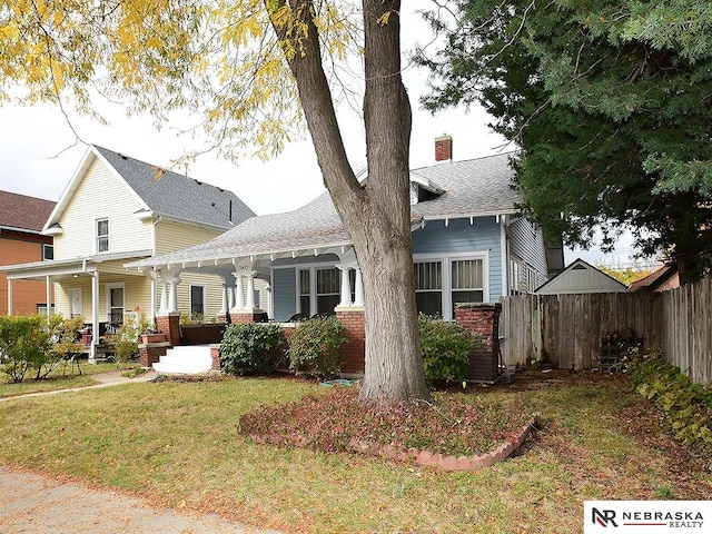 exterior space with a porch and a lawn