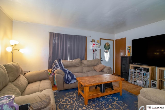 living room featuring hardwood / wood-style flooring and ornamental molding