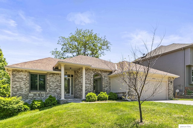 2119 N 144th Ave, Omaha, NE 68116 - view of front facade with an attached garage, brick siding, driveway, and a front yard