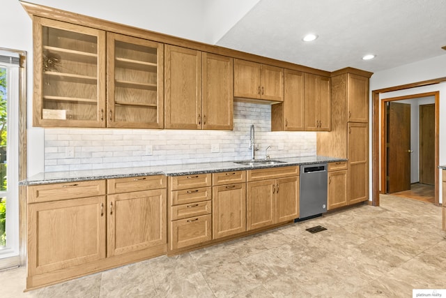 2119 N 144th Ave, Omaha, NE 68116 - kitchen with a sink, dishwasher, stone countertops, decorative backsplash, and glass insert cabinets
