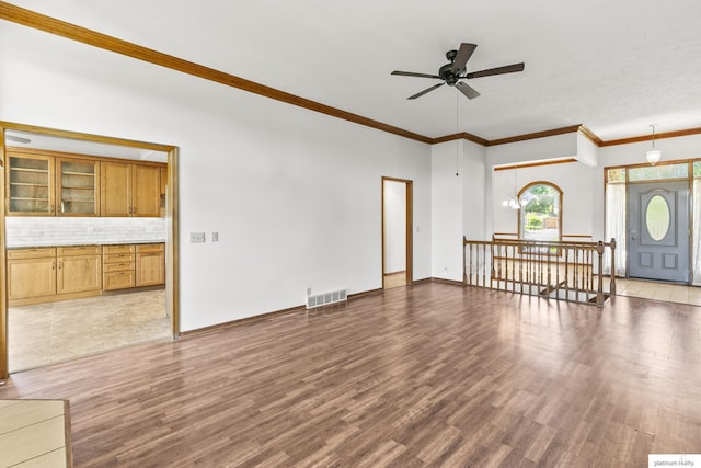 2119 N 144th Ave, Omaha, NE 68116 - unfurnished living room featuring ceiling fan, wood finished floors, ornamental molding, and baseboards