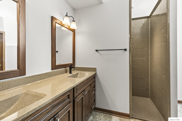 2119 N 144th Ave, Omaha, NE 68116 - bathroom with double vanity, baseboards, and a tile shower