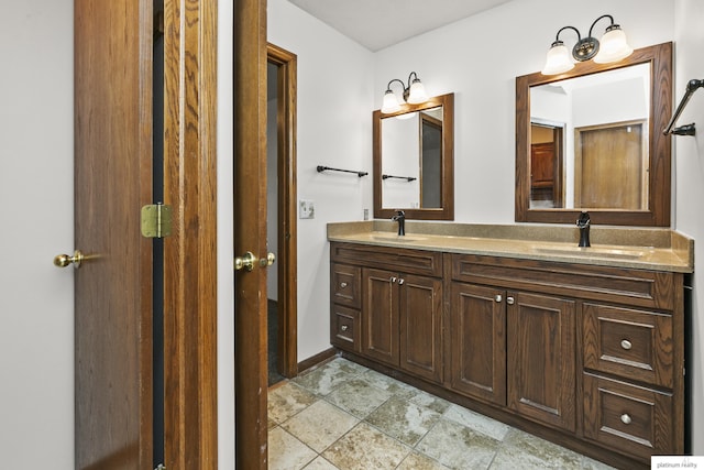 2119 N 144th Ave, Omaha, NE 68116 - full bath featuring double vanity, stone finish flooring, and baseboards