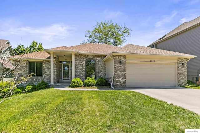2119 N 144th Ave, Omaha, NE 68116 - view of front of property with an attached garage, brick siding, concrete driveway, and a front lawn
