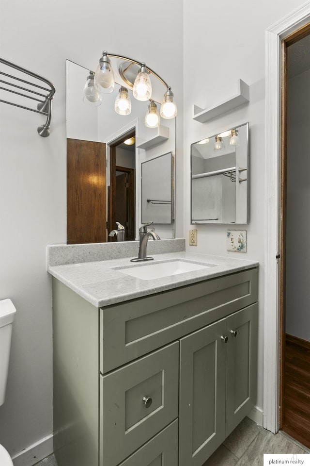 2119 N 144th Ave, Omaha, NE 68116 - bathroom with toilet, vanity, and baseboards