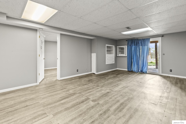 2119 N 144th Ave, Omaha, NE 68116 - spare room featuring a drop ceiling, baseboards, and wood finished floors