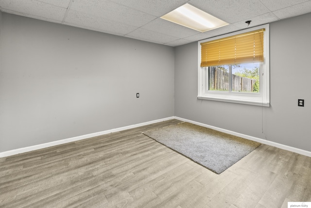 2119 N 144th Ave, Omaha, NE 68116 - unfurnished room featuring a drop ceiling, baseboards, and wood finished floors