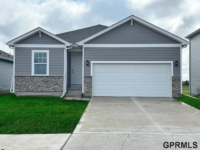 view of front of house featuring a garage and a front lawn