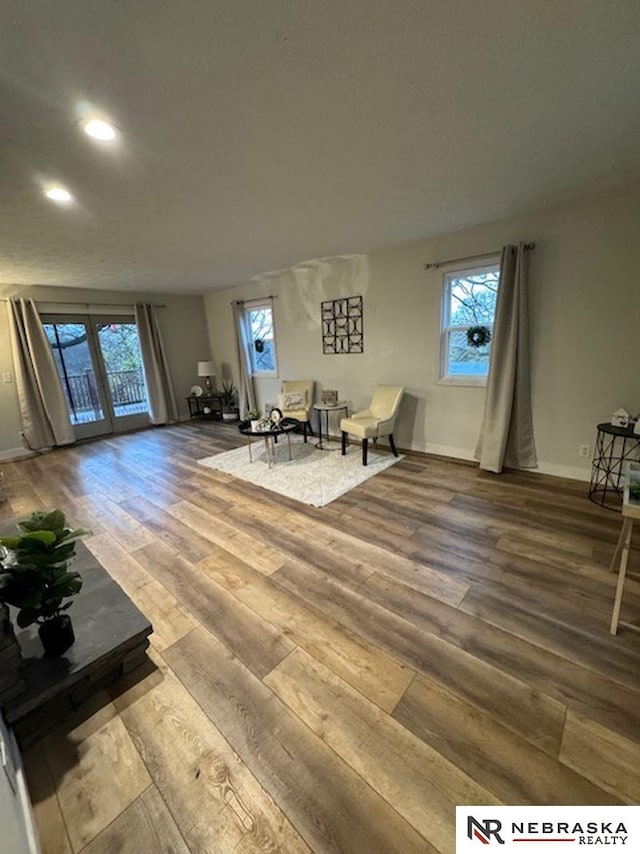 living area with hardwood / wood-style floors and french doors