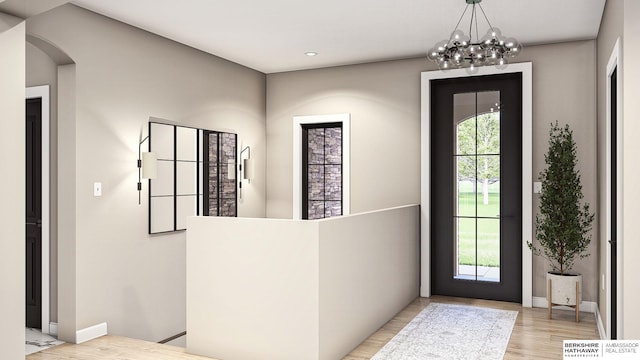 entrance foyer featuring light hardwood / wood-style floors and a notable chandelier