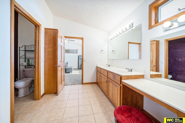 bathroom featuring lofted ceiling, tile patterned floors, toilet, a textured ceiling, and vanity