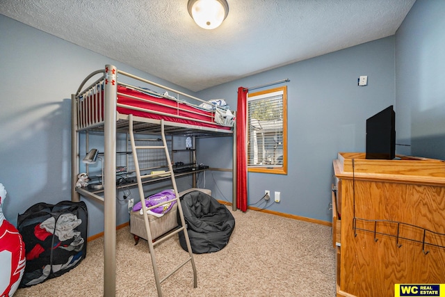 bedroom featuring a textured ceiling and carpet flooring