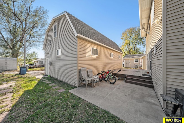 back of house featuring a lawn and a wooden deck