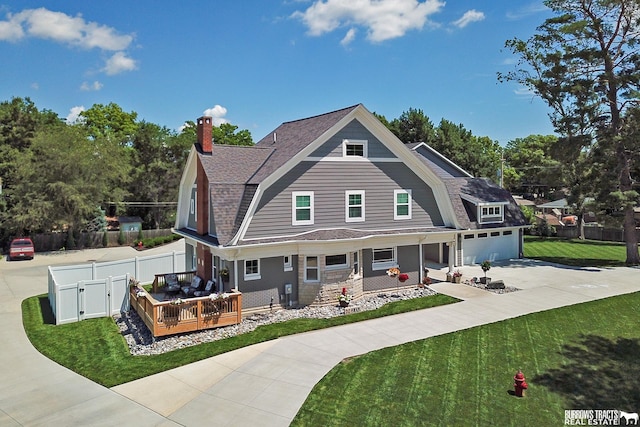 view of front of property featuring a front lawn and a deck