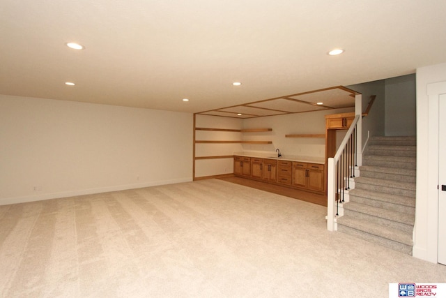 basement with light colored carpet and sink