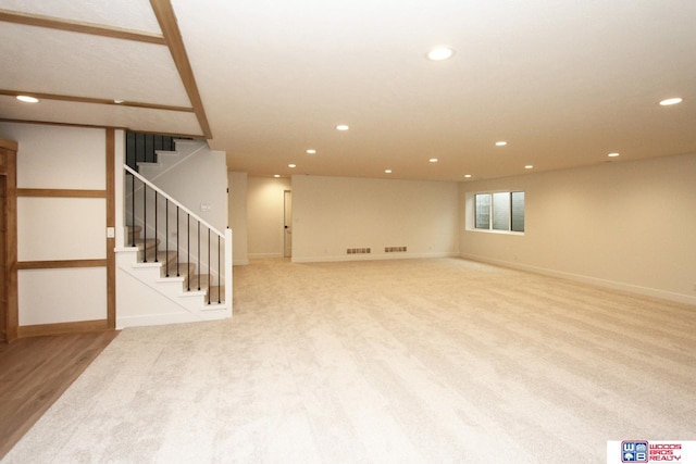 basement featuring light colored carpet