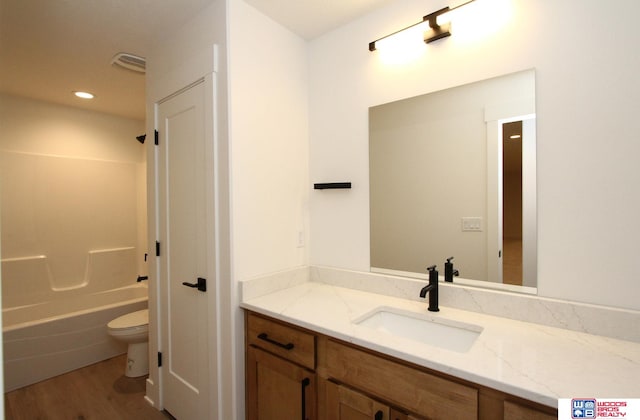 full bathroom with toilet, shower / bath combination, vanity, and hardwood / wood-style floors