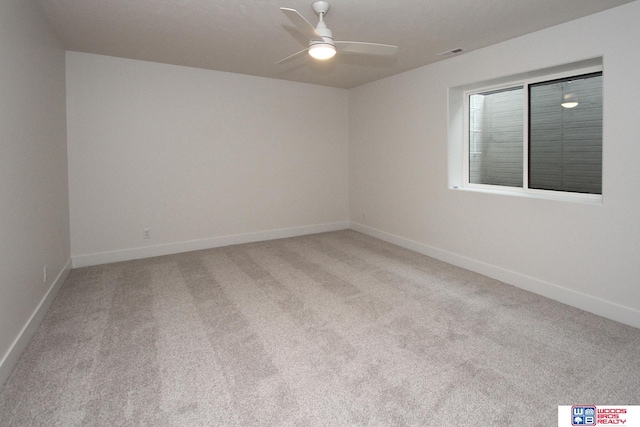 spare room with light colored carpet and ceiling fan