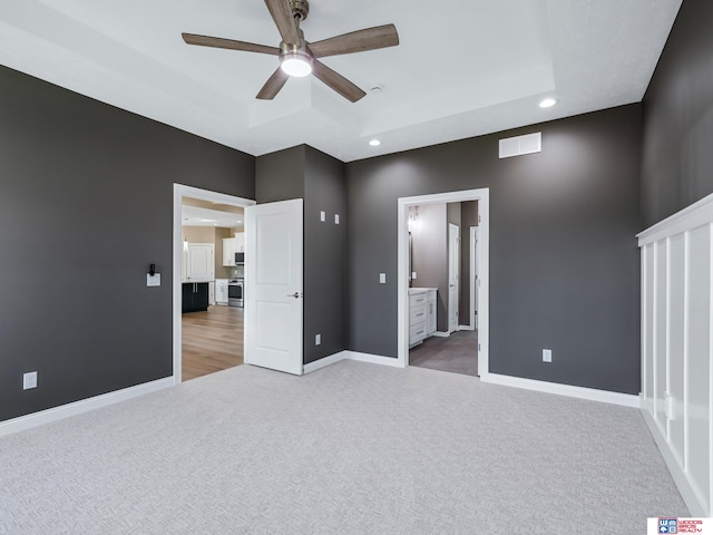 unfurnished bedroom featuring connected bathroom, ceiling fan, and carpet floors