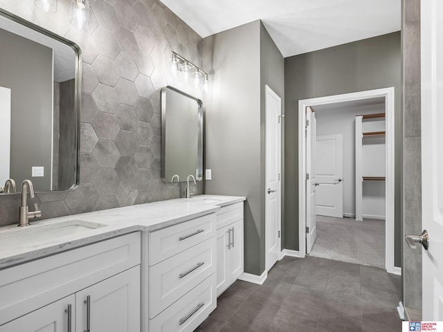 bathroom with tile walls, tile patterned flooring, and vanity