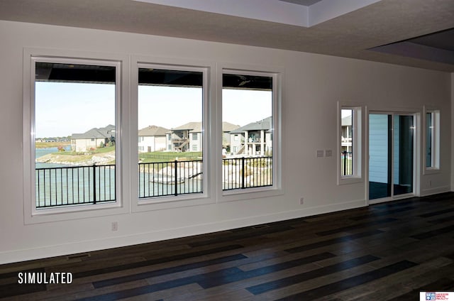 empty room with dark hardwood / wood-style flooring