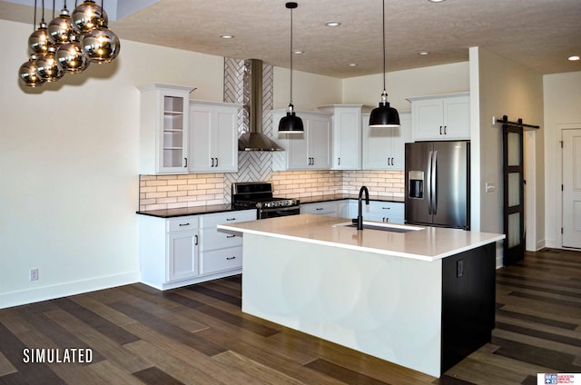 kitchen featuring white cabinetry, sink, appliances with stainless steel finishes, wall chimney exhaust hood, and pendant lighting