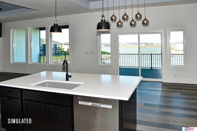 kitchen with stainless steel dishwasher, a wealth of natural light, a center island with sink, and sink