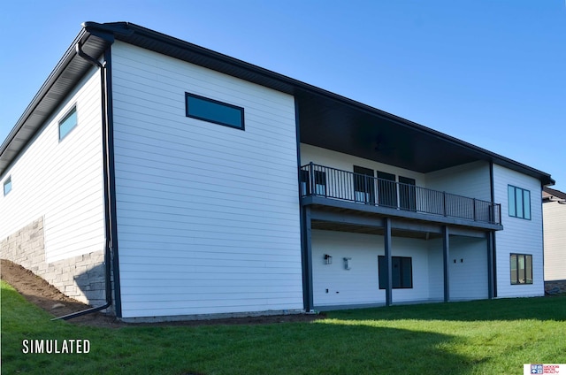 back of house with a yard and a balcony