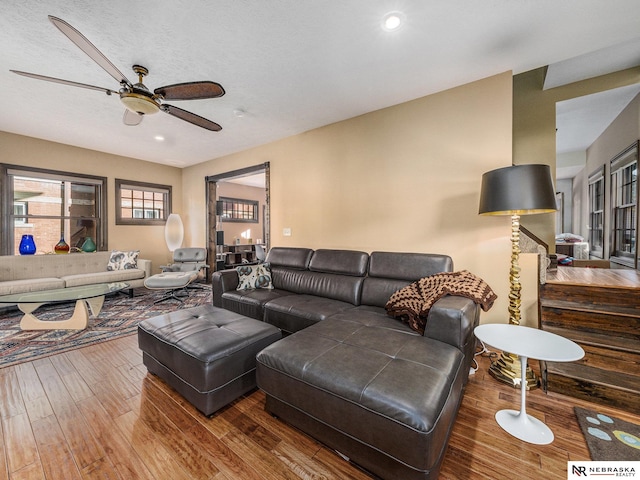 living room featuring ceiling fan and hardwood / wood-style flooring