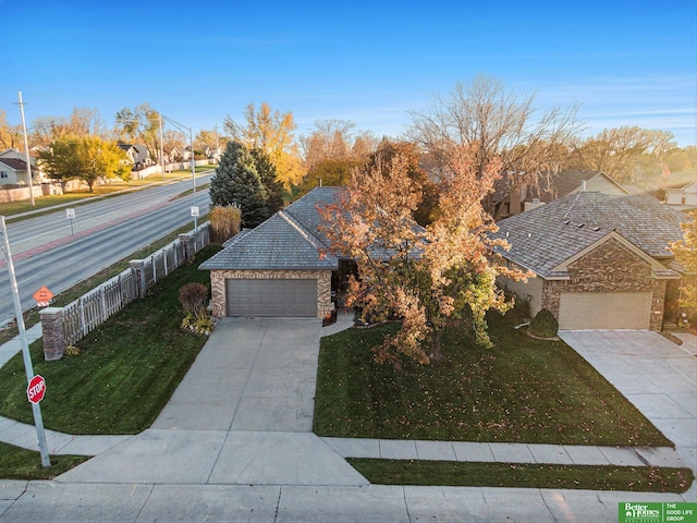 view of front of home with a front lawn and a garage