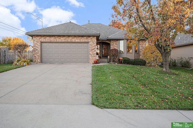 single story home featuring a front lawn and a garage