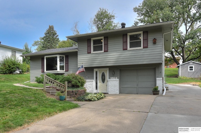 split level home with a front lawn and a garage