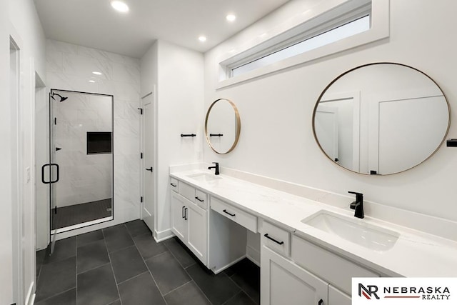 bathroom with vanity and a shower with shower door