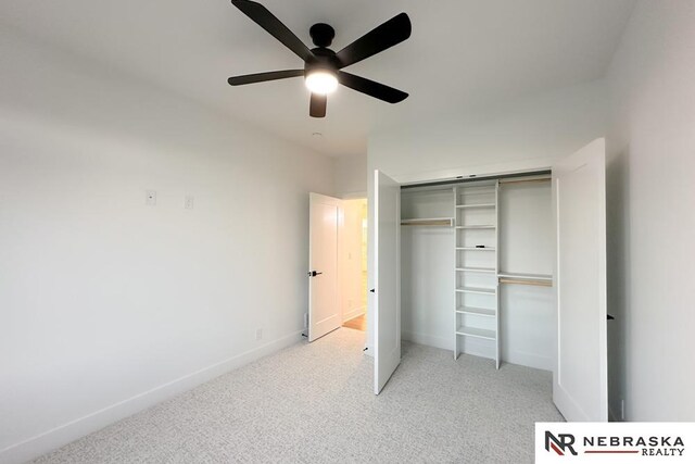 unfurnished bedroom with a closet, ceiling fan, and light carpet