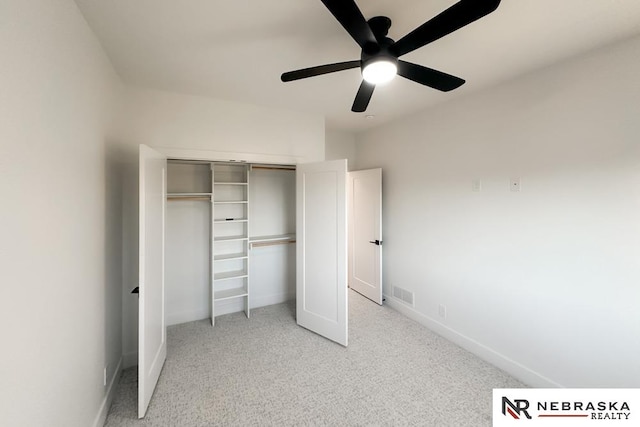 unfurnished bedroom featuring ceiling fan, a closet, and light carpet