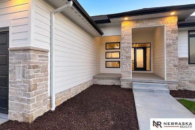 view of exterior entry with covered porch