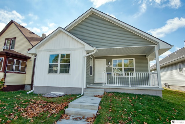 view of front of property with covered porch and a front yard