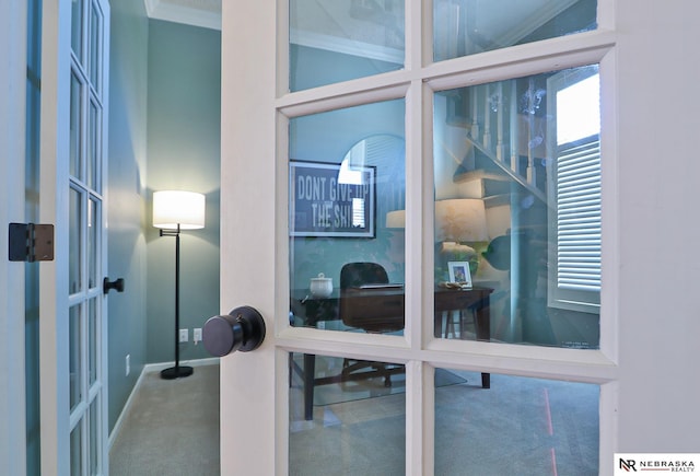 room details with french doors, carpet floors, and ornamental molding