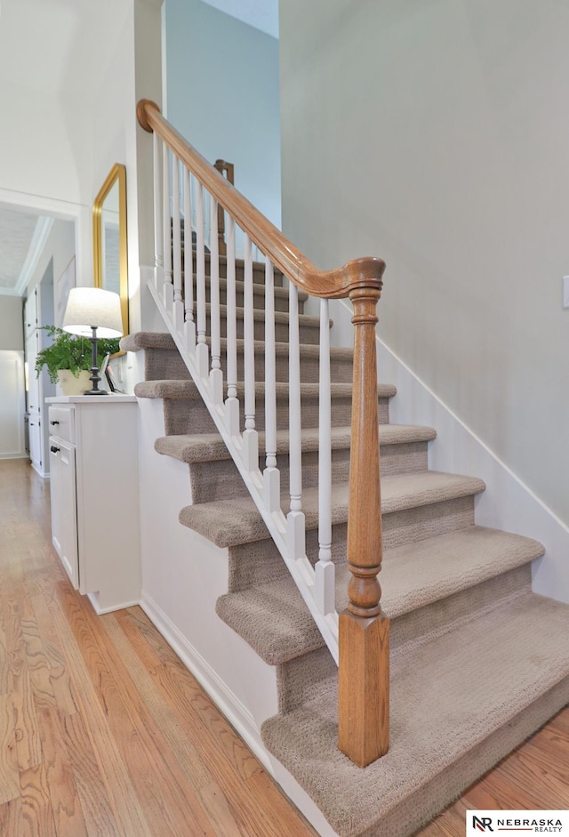 stairs with hardwood / wood-style flooring