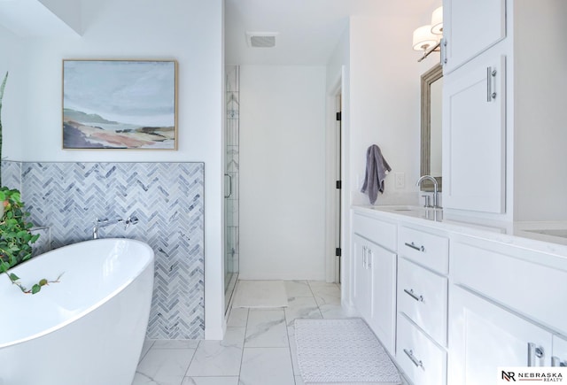 bathroom featuring vanity, tile walls, and shower with separate bathtub